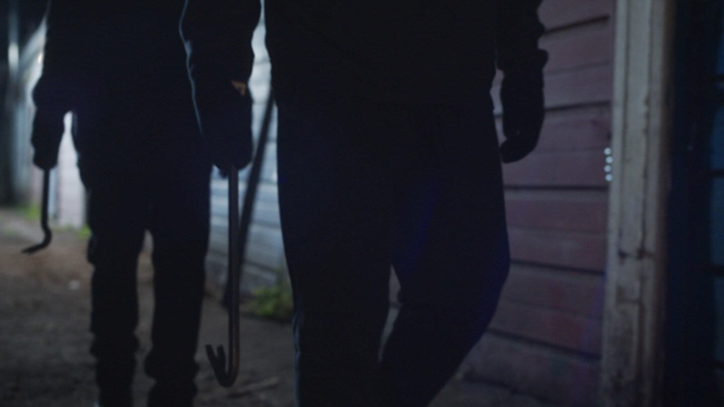 Two people holding crowbars